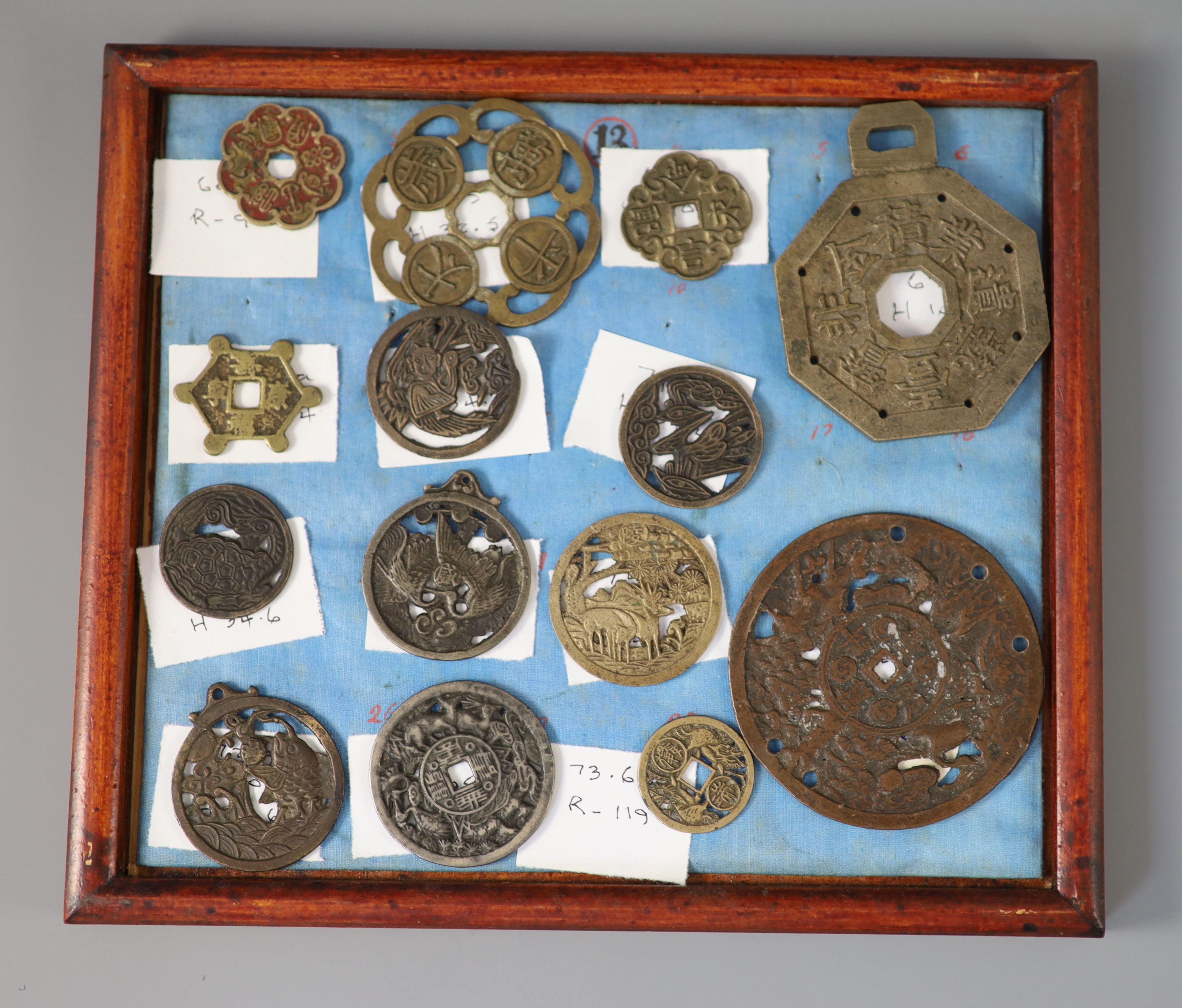 A group of 99 Korean bronze and metal amulets or charms, 19th/20th century